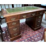 An Edwardian mahogany kneehole desk with inset leather top, 8 pedestal and 1 frieze drawers