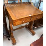 A 19th Century burr walnut slope front writing desk with single drawer, hinged lid, carved frieze