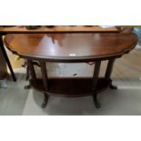 A mahogany reproduction 2 tier occasional table with demi-lune top, on paw feet