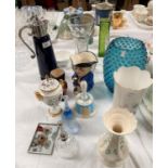 A Wade blue glazed claret jug with silver plated mounts; a Belleek vase; a Coalport covered vase;