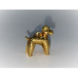 A yellow metal charm in the form of a Poodle. Stamped 750 (2.6g)