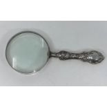 An Edwardian magnifying glass with hallmarked silver embossed handle, Birmingham 1901/2
