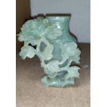 A Chinese green jade vase with carved and pierced decoration of flowers, 13 cm