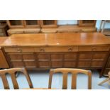 A 1960's Nathan teak dining suite comprising oval extending table, 6 (4 + 2) high back chairs, and