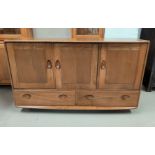An Ercol light oak sideboard of 3 cupboards and 2 drawers
