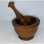 A small late 19th / early 20th century turned wood pestle and mortar