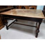 A Victorian oak dining table with rectangular plank top, on turned legs