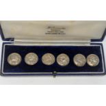 A cased set of 6 hallmarked silver buttons with embossed portrait decoration, Chester - date