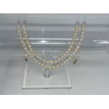 A double strand cultured pearl necklace, the clasp stamped '375'