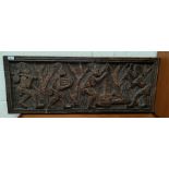 An African carved hardwood relief plaque depicting 4 figures at work, signed P.H.KALENGA, 39 x 100cm