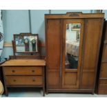 A 1930's Oak three piece bedroom suite comprising oak single mirror door wardrobe, two height