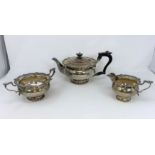 A hallmarked silver 3 piece tea set in the Georgian style, circular with scalloped shell borders