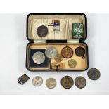 An American silver dollar; a Canadian silver dollar; a 1935 crown; other coins and medallions; a