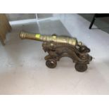 A brass miniature cannon on cast iron dragon gun carriage