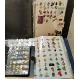 A collection of enamel lapel buttons in albums