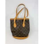 A Louis Vuitton 'Petit Bucket' in monogram canvas and leather with purse on chain, bag interior