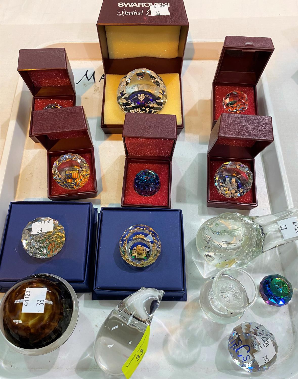 A selection of originally boxed Swarovski crystal paperweights & glassware.