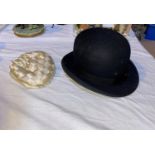 A bowler hat; a child's silk hat