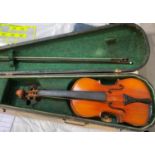 A half size violin with interior label, hard case and bow