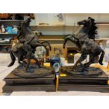A pair of bronze Marley horses on slate plinth signed Cousteau, overall height 49cm