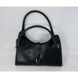A Gucci black leather handbag with twin rolled handles and silver silver tone trim, zip pocket to