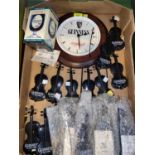 A selection of Guinness advertising items including wall clock & 21 battery operated violin