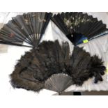 A 1920's/30's black ostrich feather fan with carved & pierced ebonized sticks 1 stick a.f. & 2
