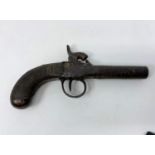 An early 19th century percussion cap muff pistol with cross hatched grip (metalwork rusted)