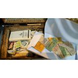 A 19th century box containing a collection of unmounted cigarette cards and vintage bus tickets