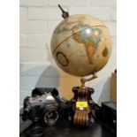 A Terrestrial Globe on wooden stand; a Canon SLR camera; a Panasonic Luminex camera