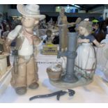 A Lladro figure - Boy in Cowboy outfit; a Lladro group - Girl by an old pump (handle detatched)