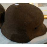 A WWII German helmet (rusted, no fittings)