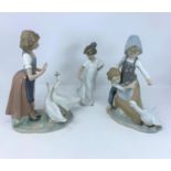 A Lladro group of young boy and girl with goose; a Nao figure of girl with two geese and a single