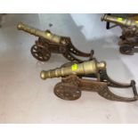 A pair of brass miniature cannons on cast iron gun carriage