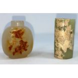 A Chinese jade coloured cylindrical item with hole to middle and a carved hard stone snuff bottle (