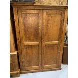 A Victorian stripped pine two door side cabinet