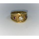 A Victorian style 18 carat hallmarked gold ring with wide shaped shank set with 2 rubied and a