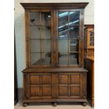 An 18th century style distressed oak bookcase/cabinet in the manner of Titchmarsh & Goodwin, the