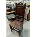 A late 17th century chair with panelled back and shaped crest