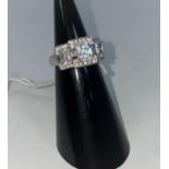 A 9 carat hallmarked gold dress ring set 3 large cushion cut diamond simulants and multiple