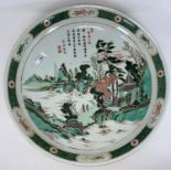 A large Chinese famille vert ceramic charger decorated with mountain scene and characters,