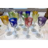 Eleven overlaid coloured wine glasses
