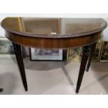 A late 19th century mahogany demi-lune side table in the Adam style, on square reeded tapering legs,