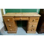 A pine kneehole desk of 7 drawers