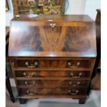 A Reprodux mahogany bureau with fall front and 4 drawers