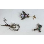 Three novelty brooches set with various stones - a fly with opal effect body and red eyes, a