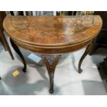 An early 20th century mahogany card table, the demi-lune fold-over top with wide crossbanding and