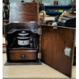 A 1930's oak, smokers cabinet with jar.