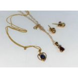 A yellow metal pendant set sapphire, on 9 carat gold chain; a 9 carat gold drop set ruby on 9