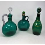 Two 19th century green glass claret jugs; a green 'Brandy' decanter; a turquoise glass wine jug
